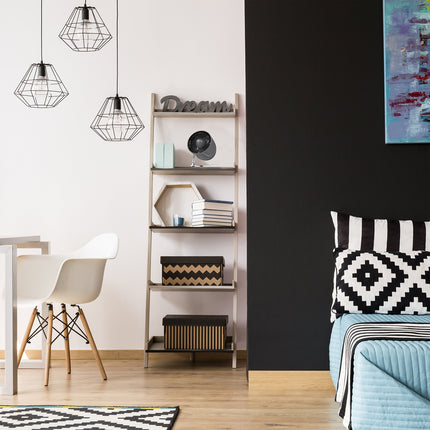 Modern room with a bed, shelves, and decorative elements. There is a gray fan on a bookshelf