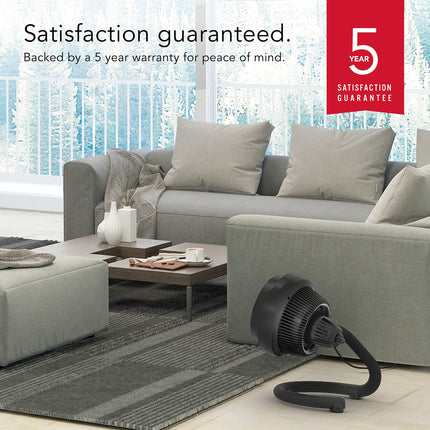 Gray sectional sofa in a living room with a 5-year satisfaction guarantee badge.