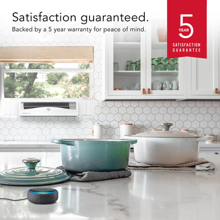 Kitchen scene with white cabinets, a window fan in the kitchen window, and a 5-year satisfaction guarantee badge.