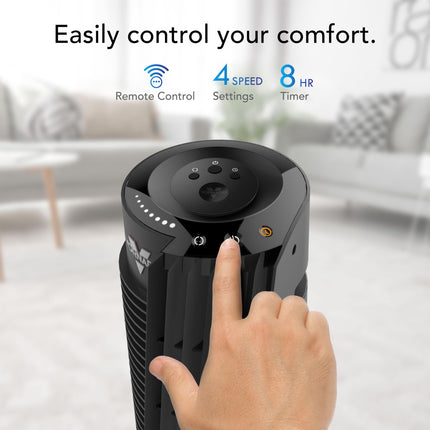 Hand operating a black tower fan with text about control features in a blurred room background