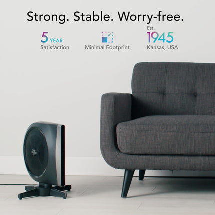 Black floor-standing fan next to a gray sofa with brand information on a white background