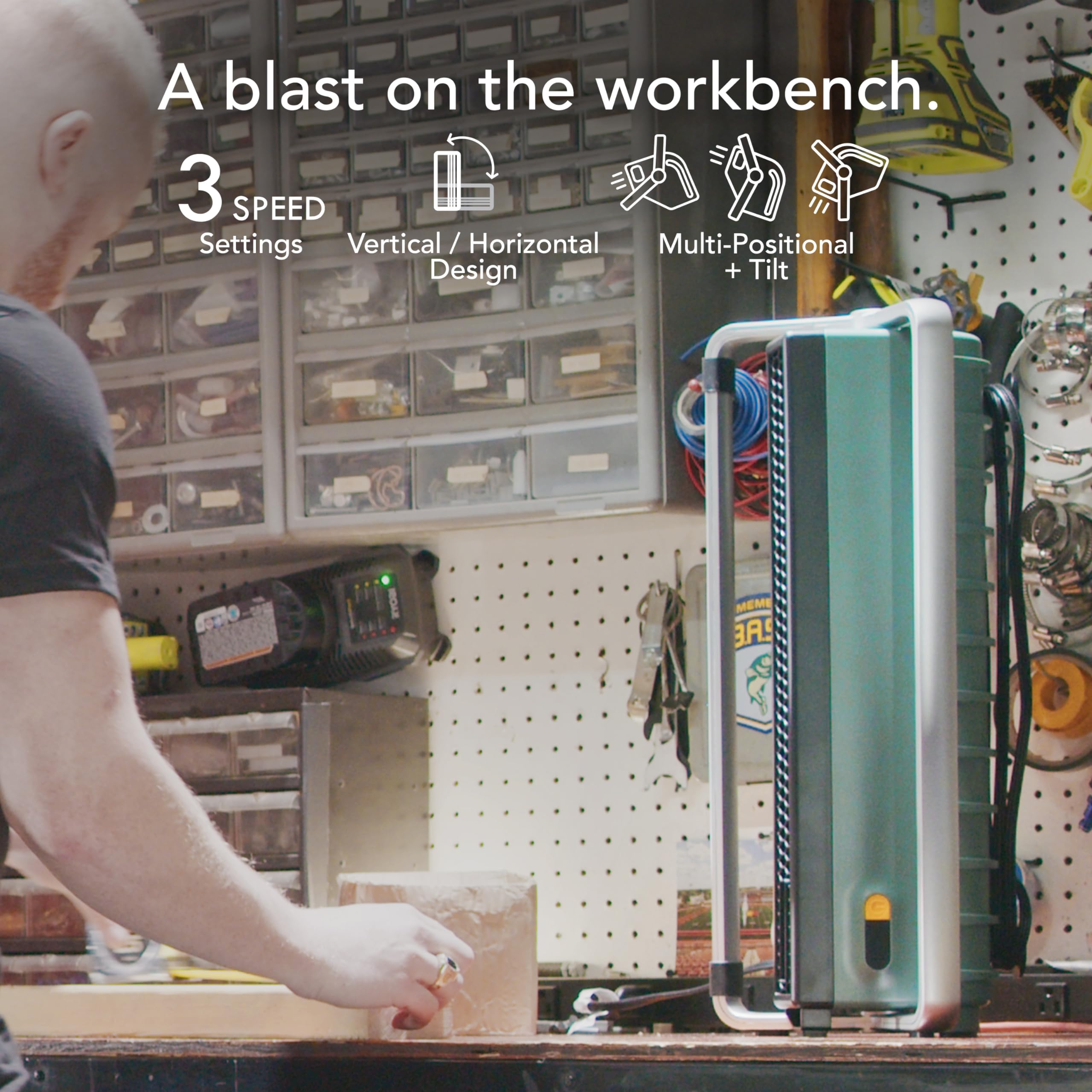 Person working on a workbench with a tool in a workshop setting