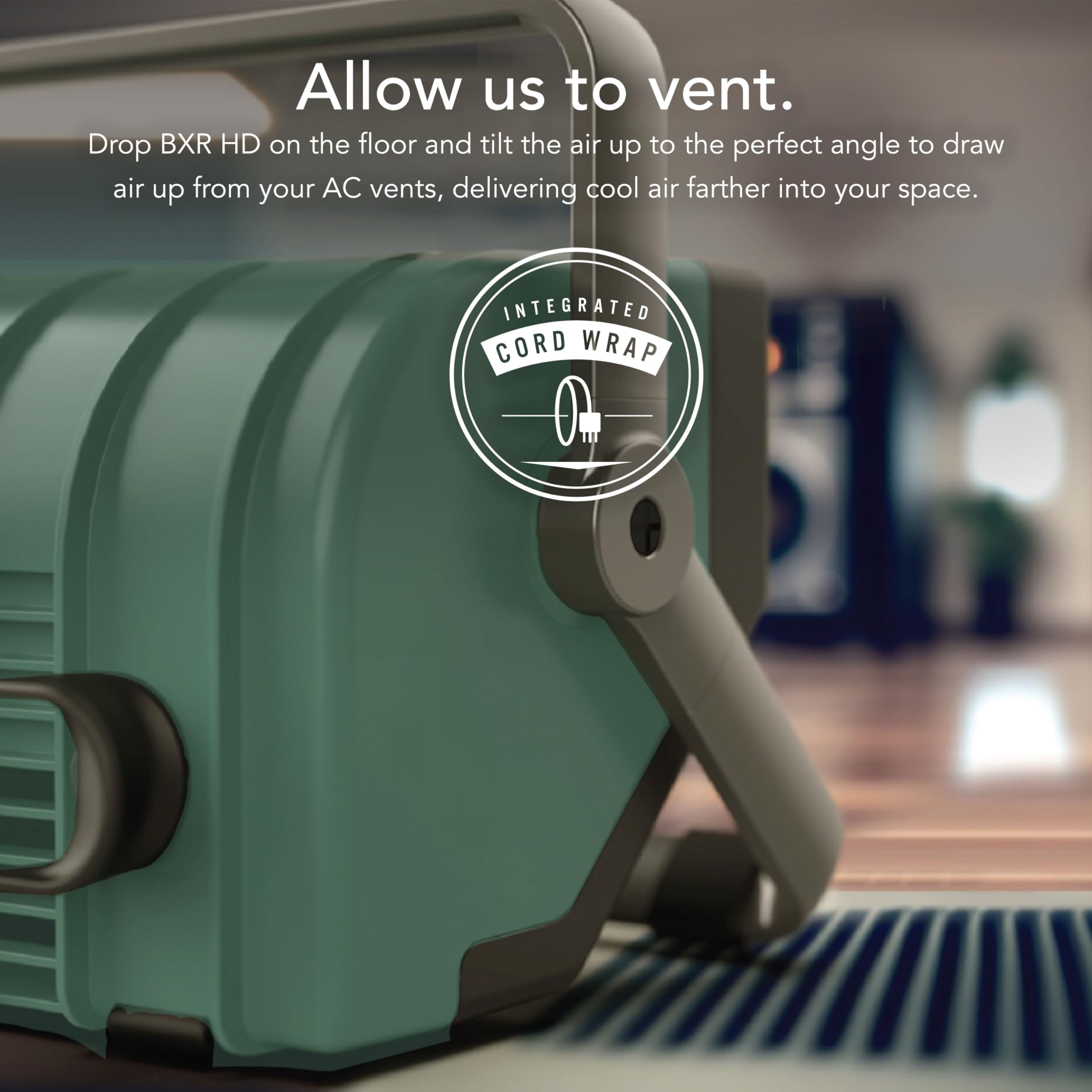 Green air circulator with text and logo on a blurred indoor background