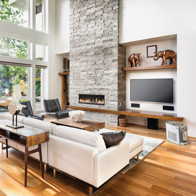 Modern living room with white sofa, wooden coffee table, and stone fireplace.