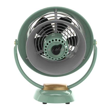 Vintage-style desk fan with a green casing and gold base on a white background