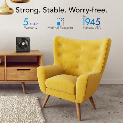 Yellow armchair in a room with a wooden side table and text about product features and establishment year.