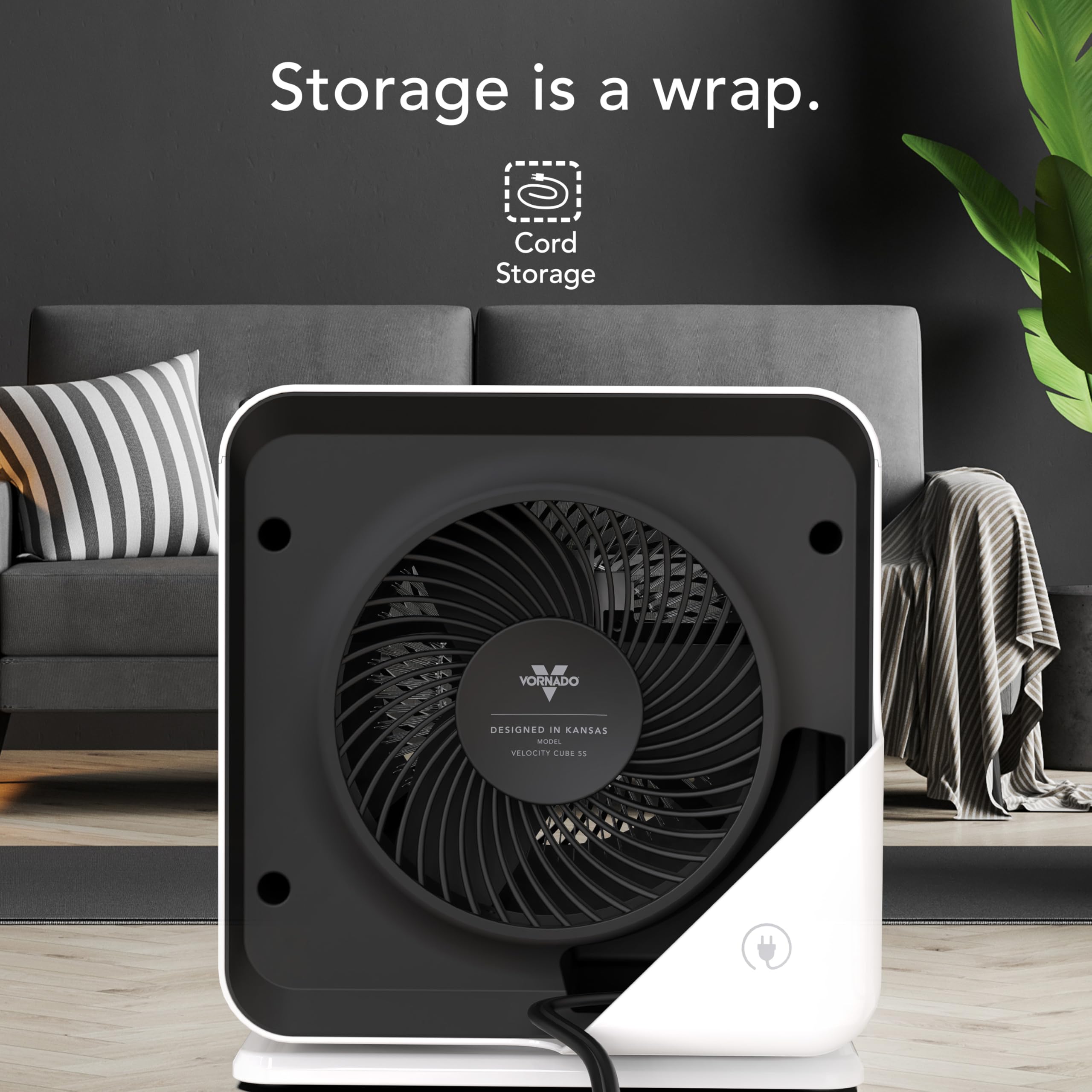 Black and white heater with 'Cord Storage' branding in a living room setting.