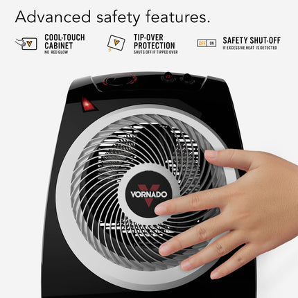 Vornado space heater with hand touching it, highlighting safety features on a white background