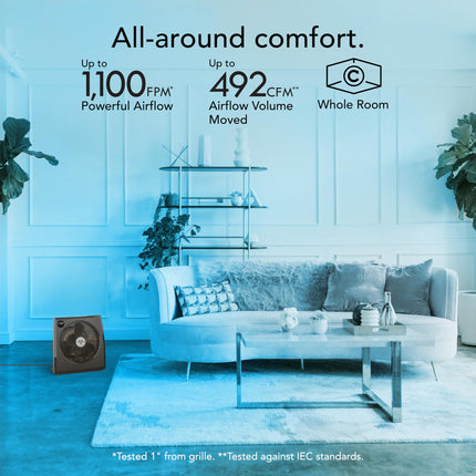Living room with a fan and text about airflow, featuring a modern sofa and decor.
