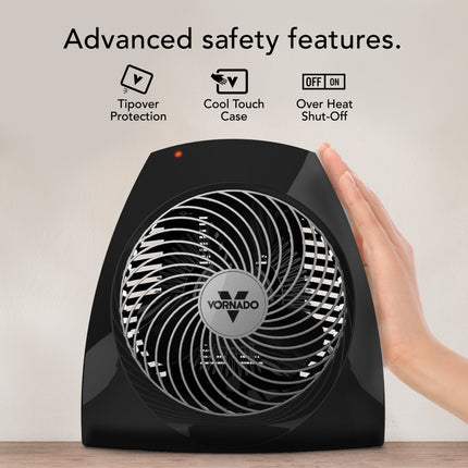 Black Vornado heater with hand touching it, featuring safety features on a light background