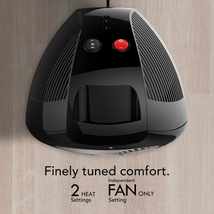 Black and gray electric heater with control buttons on a wooden surface