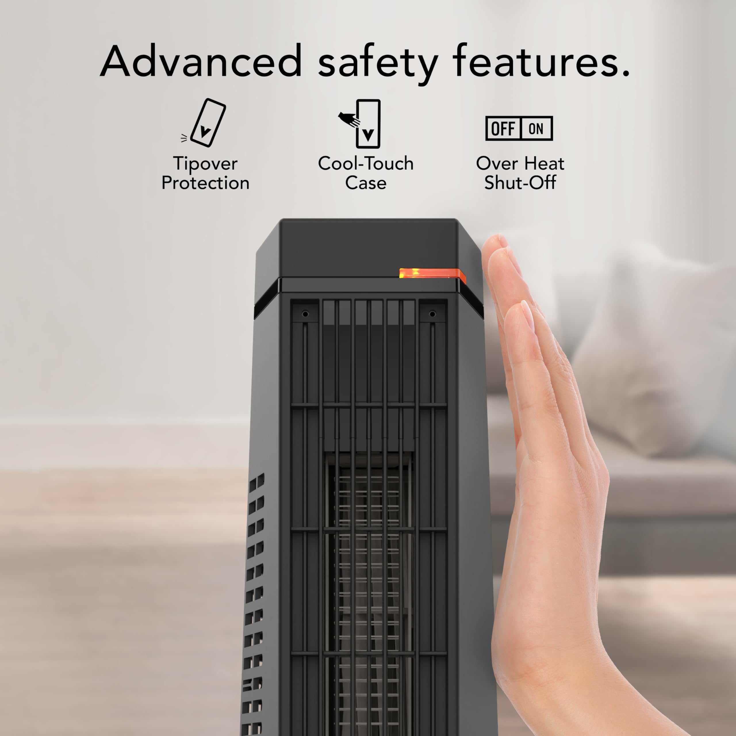Hand pressing a button on a space heater with safety feature icons above.