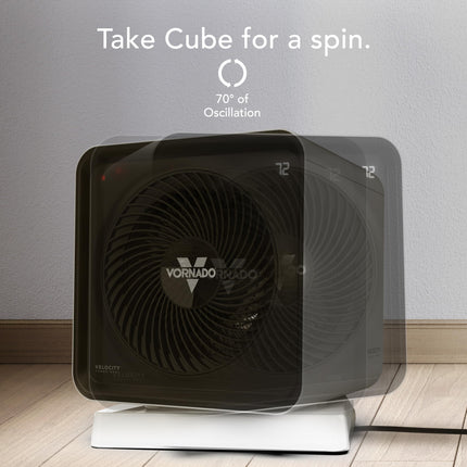 Black Vornado Cube heater on a wooden floor with a gray wall background