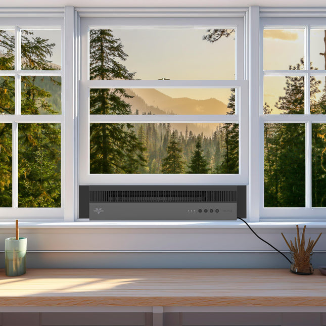 Window with a view of trees and mountains, featuring a modern window air circulator.