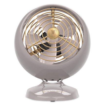 Vintage-style fan with metallic finish on a white background