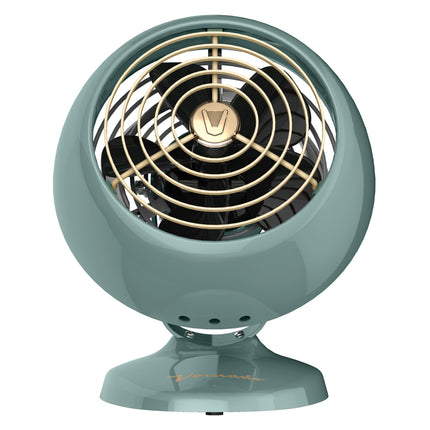 Vintage-style fan with metallic finish on a white background