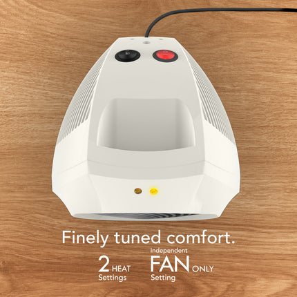 White electric heater with black and red buttons on a wooden surface, featuring text about its features.