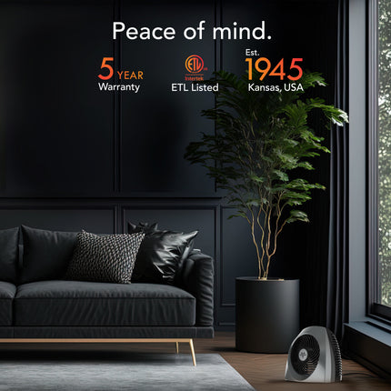 Modern living room with a black sofa, plant, and air purifier, featuring ETL Listed and 5-year warranty text.