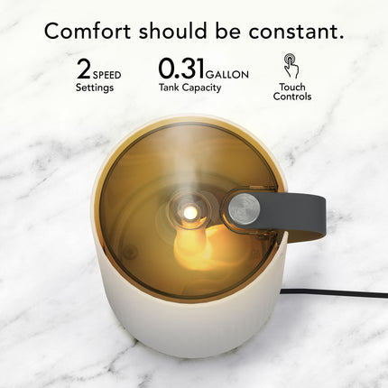 Small humidifier with gold interior and white exterior on a marble surface, featuring text about its features.