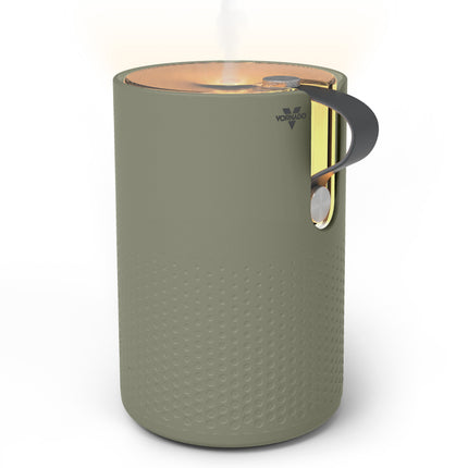 Green textured humidifier with a handle on a white background