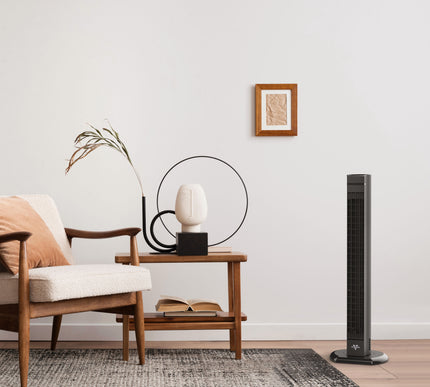 Modern living room with a tower fan, armchair, and side table.