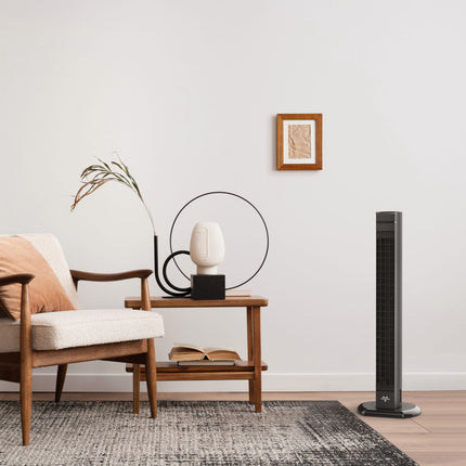 Modern living room with a tower fan, armchair, and side table.