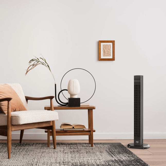 Modern living room with a tower fan, armchair, and side table.