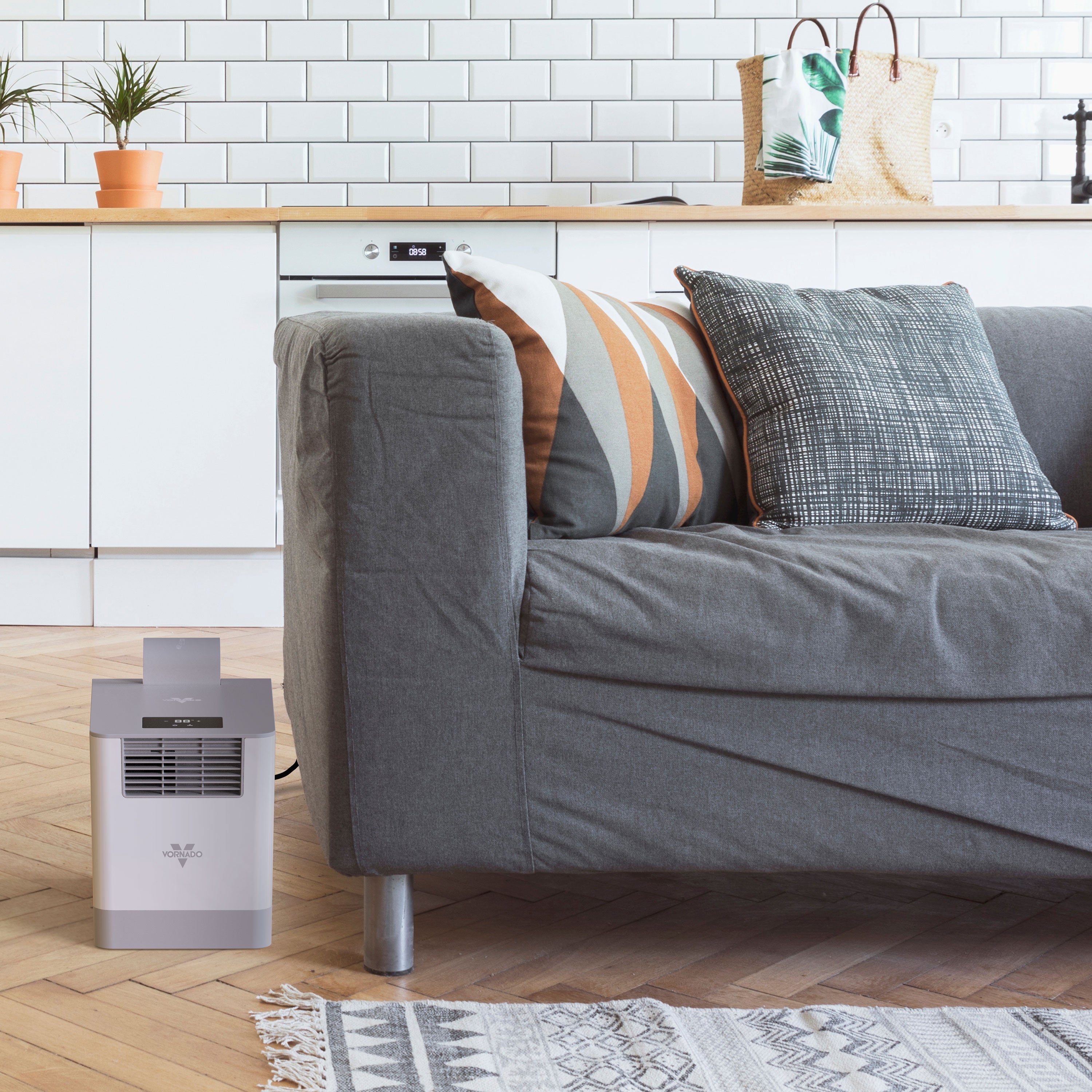 Gray sofa with decorative pillows in a living room setting with a humidifier