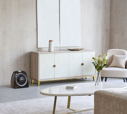Modern living room with a white sideboard, coffee table, and decorative items.