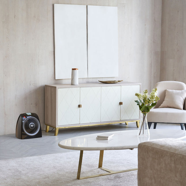 Modern living room with a white sideboard, coffee table, and decorative items.