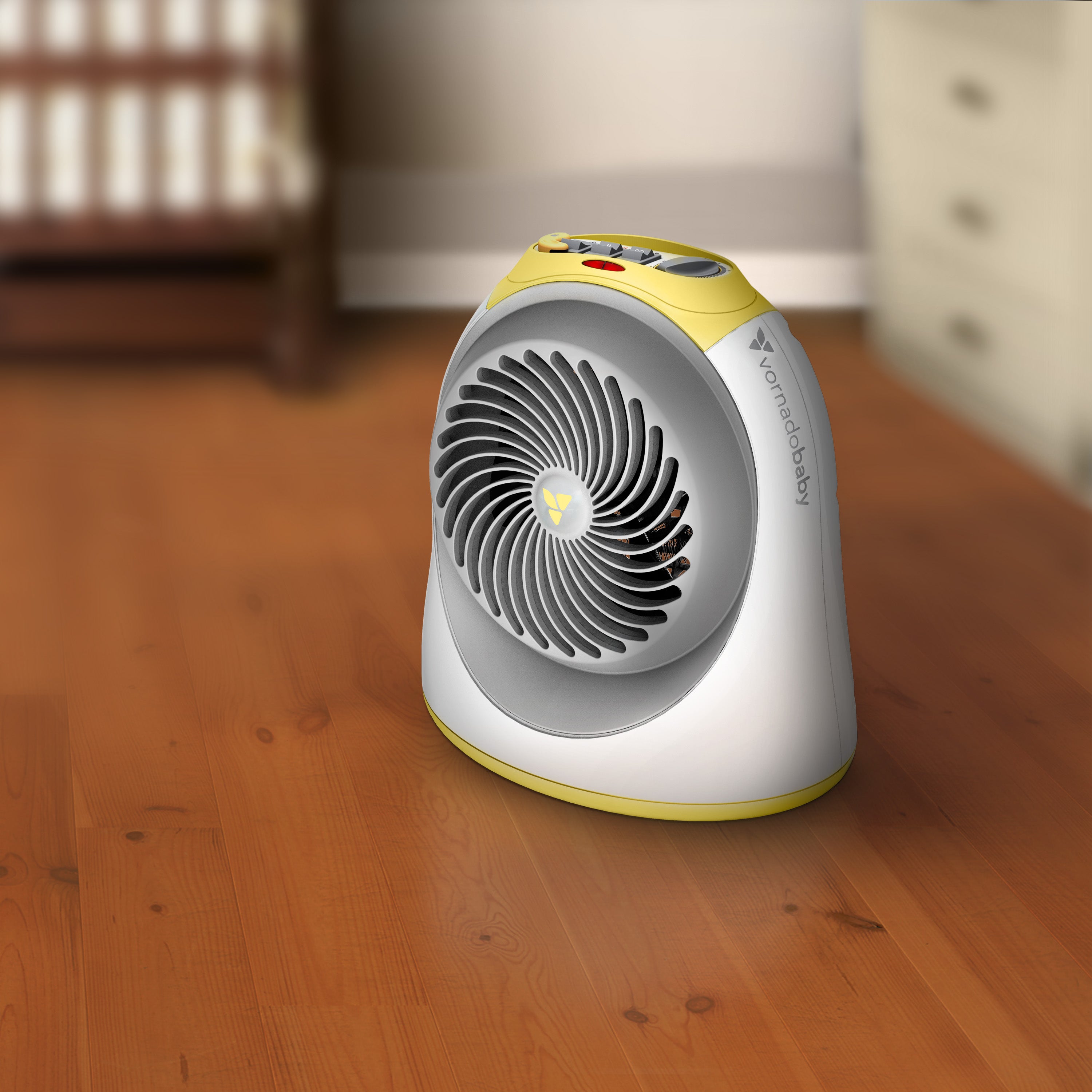 Portable space heater on a wooden floor with a blurred background
