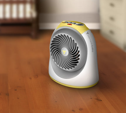 Portable space heater on a wooden floor with a blurred background