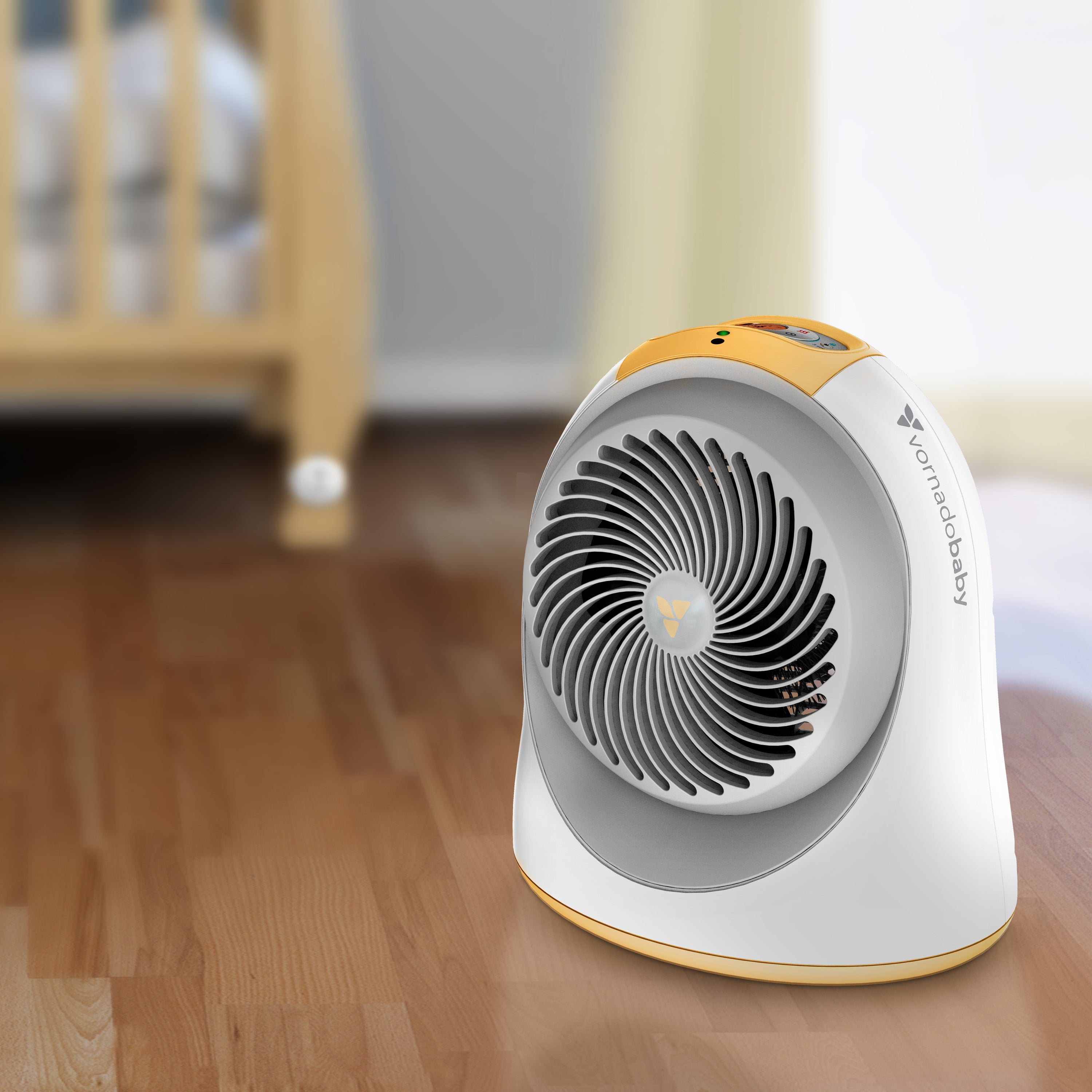 Portable space heater on a wooden floor with a blurred background