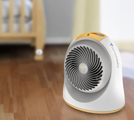 Portable space heater on a wooden floor with a blurred background