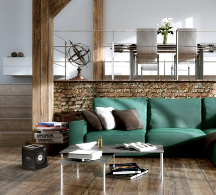 Modern living room with a teal sofa, coffee table, and decorative items.