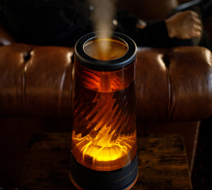 Decorative humidifier emitting steam on a brown leather couch