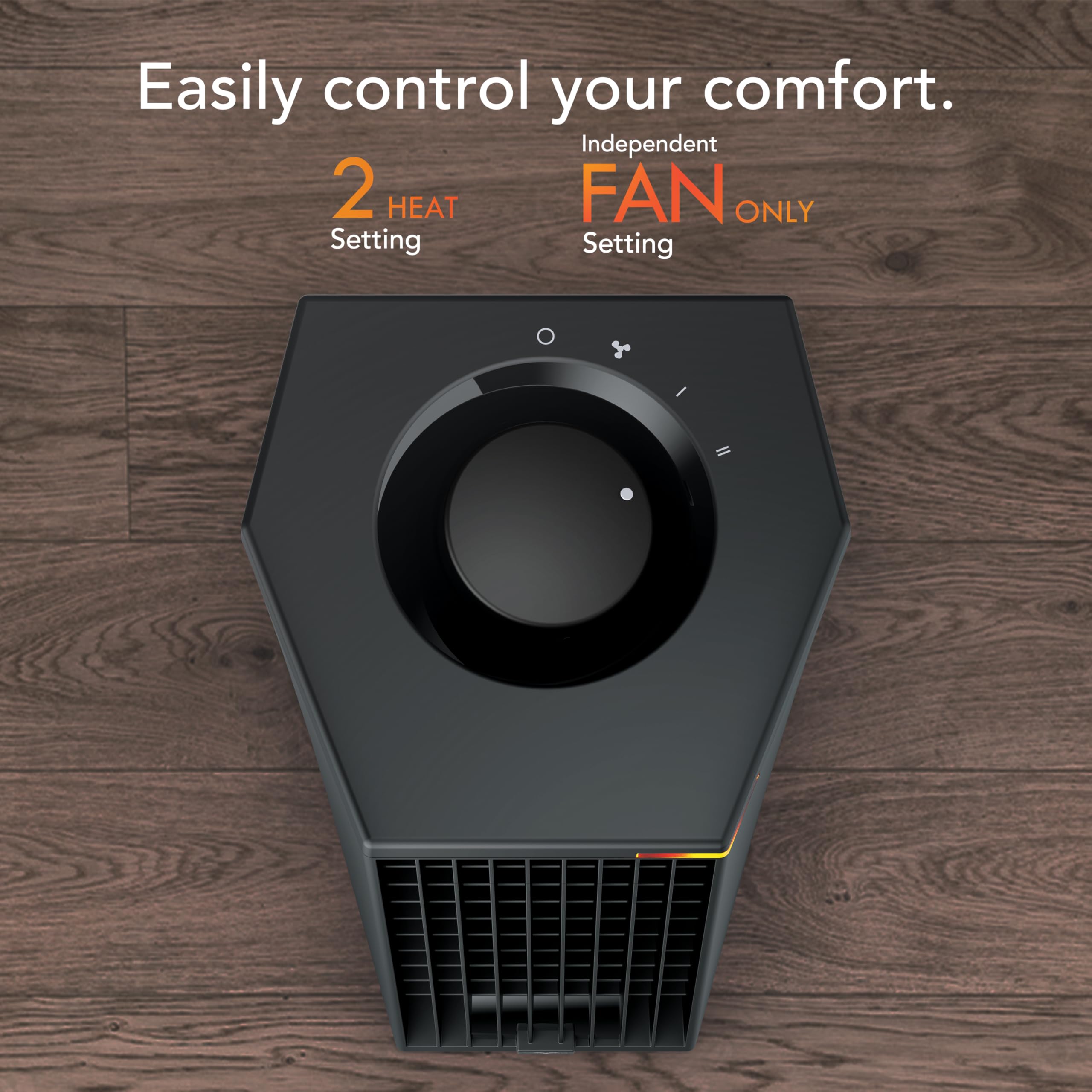 Black heater on a wooden floor with text about control settings.