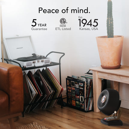 Living room with a record player, vinyl records, and a fan, featuring a 5-year guarantee and ETL Listing.