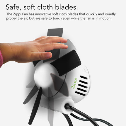Zippi fan with soft cloth blades and a hand touching it, on a white background.