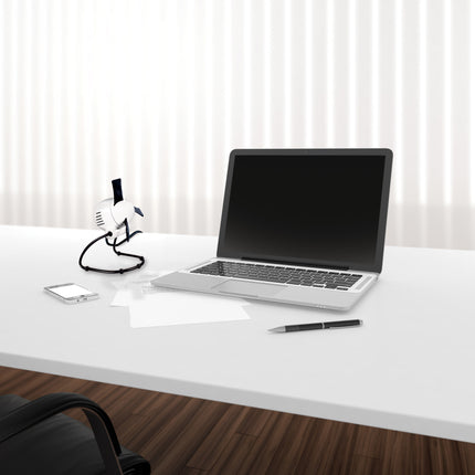 Laptop on a white desk with a smartphone and desk fan, against a white curtain background