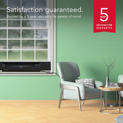 Modern room with window fan, chair, and 5-year satisfaction guarantee badge