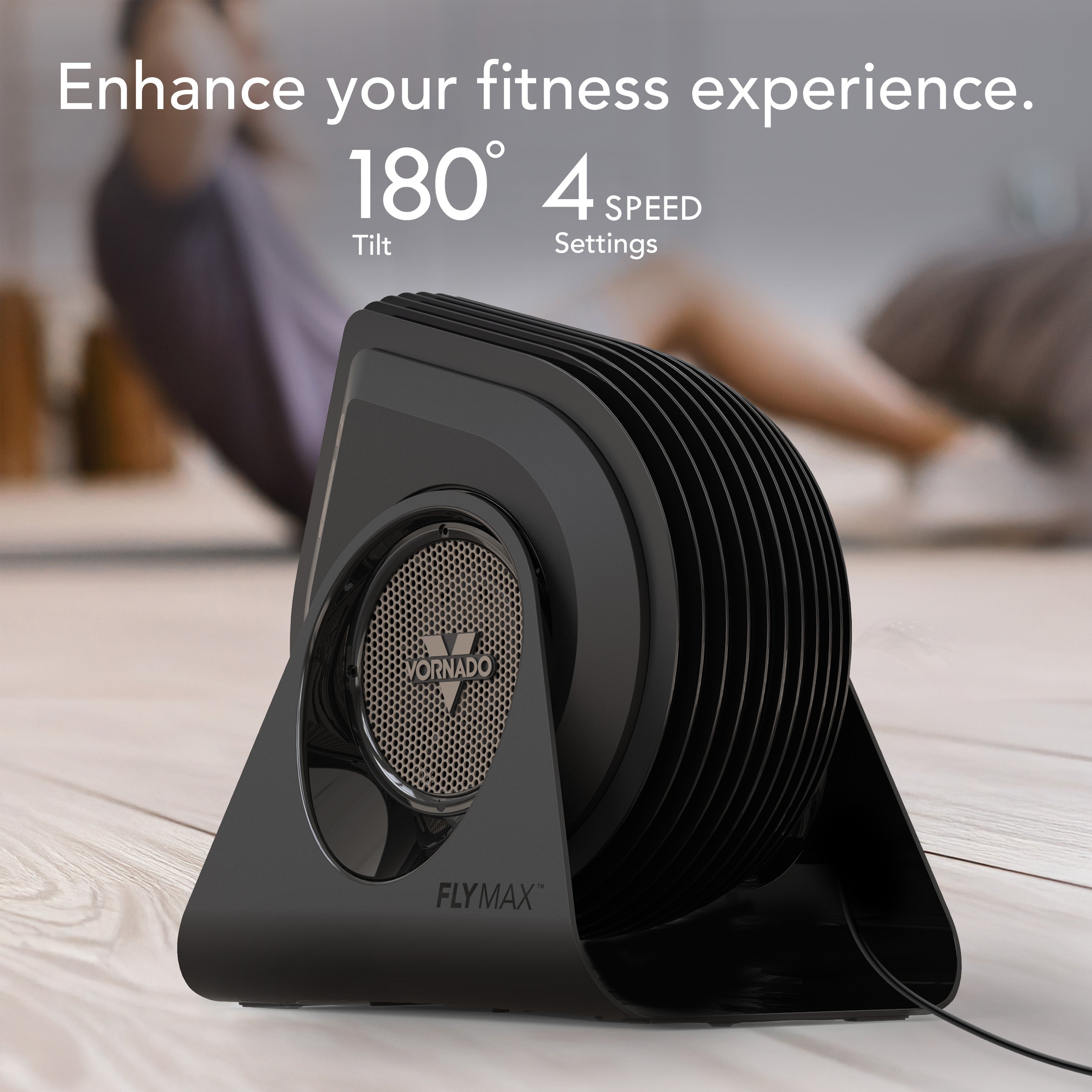 Black fan with text 'Enhance your fitness experience' and product features on a wooden floor.