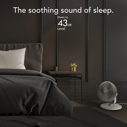 Modern bedroom with a bed and a fan, featuring text about noise level.