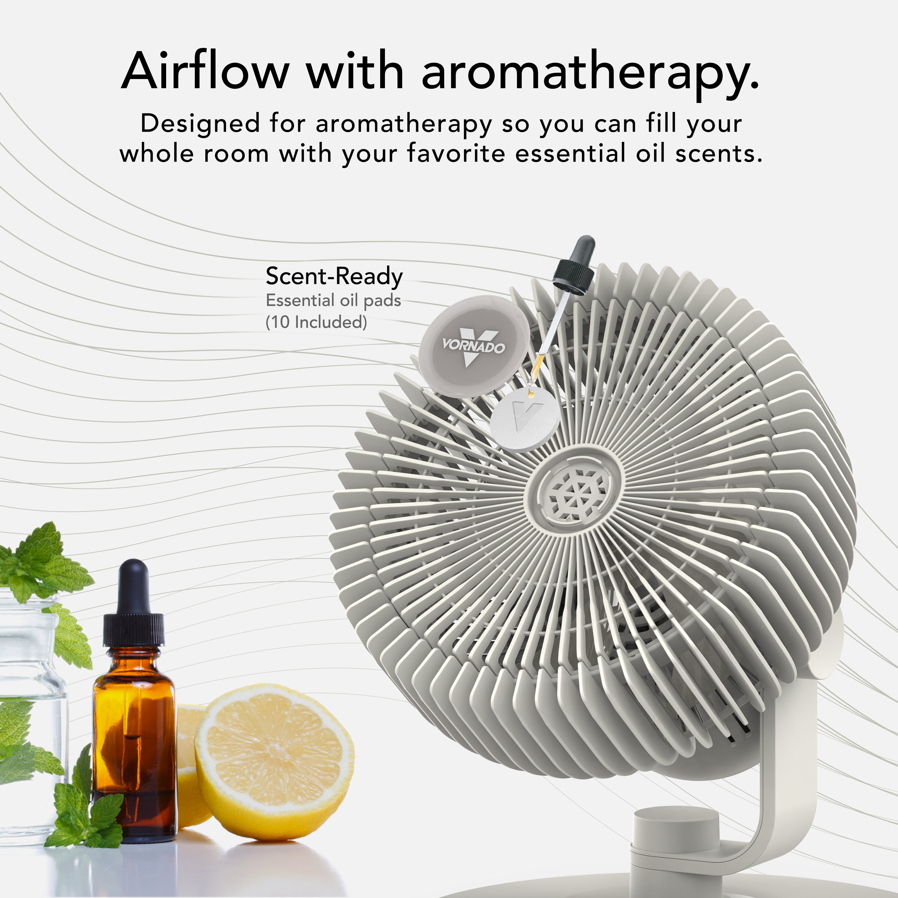 White fan with essential oil bottles and lemon on a white background, promoting aromatherapy.