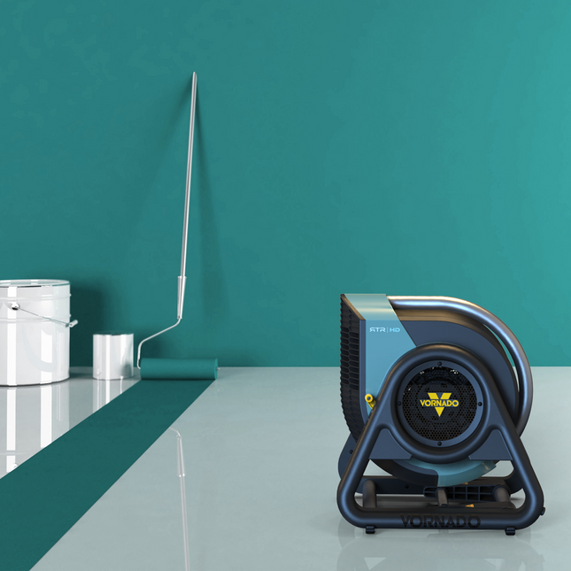 Vornado fan on a reflective surface with a teal wall in the background