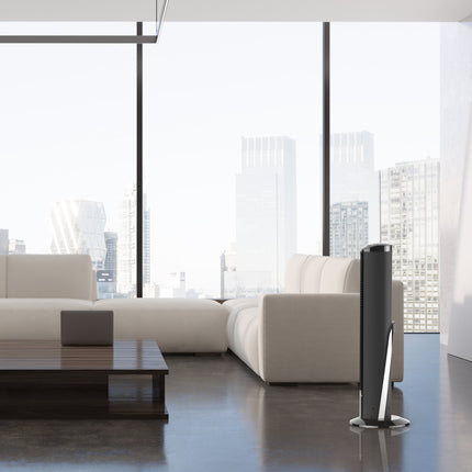Modern living room with a white sofa and a tower fan.