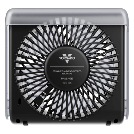 Vornado Passage travel well fan, featuring a black central fan housing with a protective black slotted grille and a clear outer casing, shown against a plain white background.