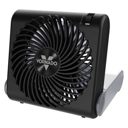 A black Vornado portable fan with a circular protective grille and a gray plastic stand, shown on a plain white background.