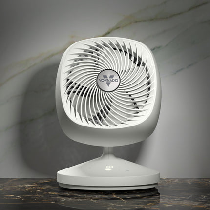 White Vornado fan on a marble surface with a gray background