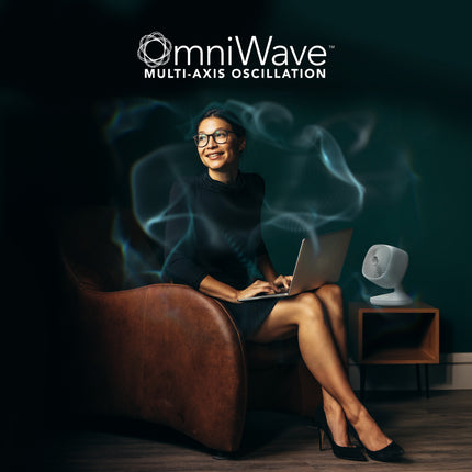 Woman using a laptop with 'omniWave' branding in the background